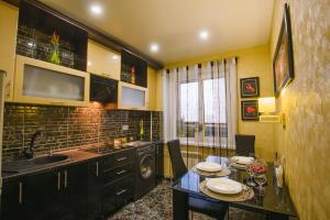 a kitchen with a table and a sink at Apartment on Lenina 49 in Salihorsk