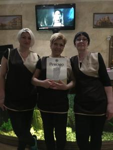 three women standing in front of a tv at Venecia Hotel & SPA in Zaporozhye