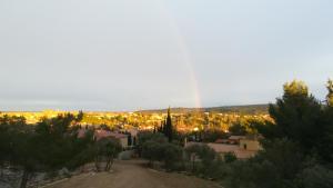 a view of a city with a rainbow in the sky at Le Studio des 3 Moulins in Sigean
