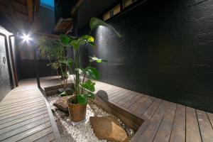 a room with two plants on a wooden floor at Wa no Kaede in Tokyo