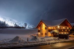 a house covered in snow at night with lights at Flachauer Bergkristall in Flachau