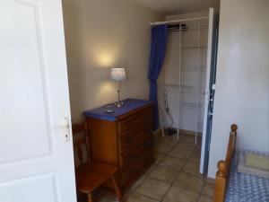 a bedroom with a dresser with a lamp on it at Mas Saint Antoine in Rognonas