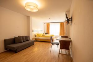 a living room with a couch and a bed at Ford Apartment Bremen City Center in Bremen