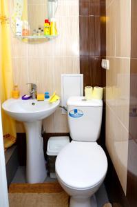 a bathroom with a white toilet and a sink at Успенский in Odesa +2 photos
