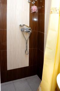 a shower with a hose in a bathroom at Успенский in Odesa