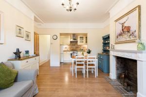 a living room with a fireplace and a kitchen at Bikki Apartments - 2 Bed - Free Parking - Own Entrance in Harrow