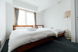 Postel nebo postele na pokoji v ubytování KéFU stay & lounge + 28 fotografií