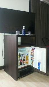 a refrigerator with a television on top of it at Hotel Emperatriz in Ocaña