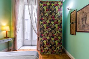 a bedroom with a wall with a floral wallpaper at Appartamento a Piazza Cavour by Wonderful Italy in Naples