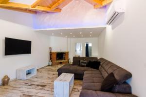 a living room with a couch and a tv at Apartments Dub in Dubrovnik