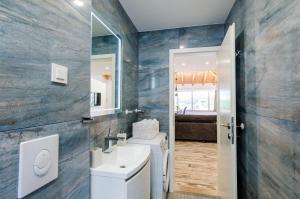 a bathroom with a sink and a mirror at Apartments Dub in Dubrovnik