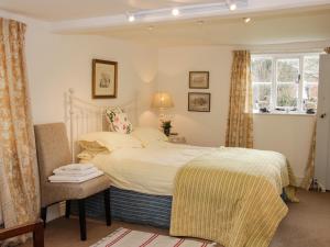 En eller flere senge i et værelse på Wolvesacre Mill Cottage