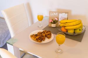 a table with a bowl of bananas and a bowl of fruit at Apartments Šmanjak in Cavtat