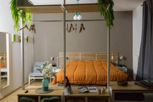 an orange bed in a room with a table at Maison Boch in Aosta
