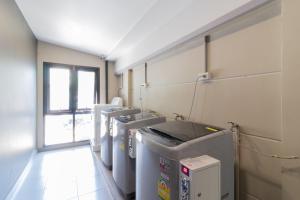 a row of washing machines in a room at Casaluxe Hotel and Resident in Bangkok