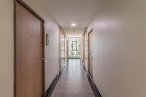 an empty hallway with doors and a hallwayngth at Casaluxe Hotel and Resident in Bangkok