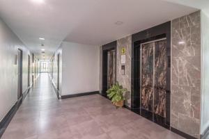 a hallway of a building with a plant on the wall at Casaluxe Hotel and Resident in Bangkok +61 photos