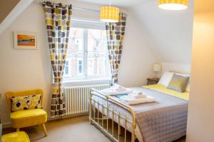a small bedroom with a bed and a window at No4 Cromer in Cromer