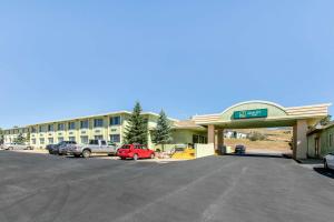 a hotel with cars parked in a parking lot at Quality Inn Rawlins I-80 in Rawlins