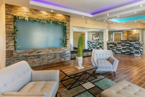 a lobby with two chairs and a large screen at Quality Inn Rawlins I-80 in Rawlins