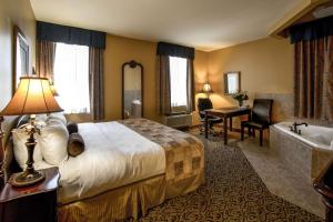 a hotel room with a bed and a bath tub at The Parlour Inn Ascend Hotel Collection in Stratford