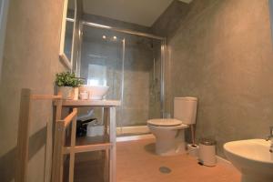 a bathroom with a shower and a toilet and a sink at Coastal View Flat - amazing views over the Atlantic in Viana do Castelo +22 photos