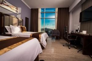 Postel nebo postele na pokoji v ubytování Hotel City Plaza & Suites