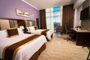 Postel nebo postele na pokoji v ubytování Hotel City Plaza & Suites