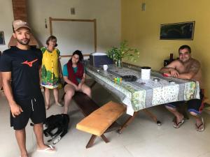 a group of people standing around a table at Casa paRABEns! in Sertão do Taquari