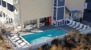 arial view of a building with a pool and chairs at Atlantic View Hotel in Dewey Beach
