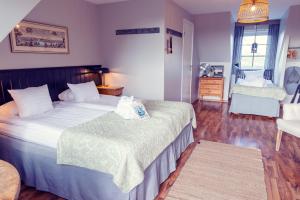 Ένα ή περισσότερα κρεβάτια σε δωμάτιο στο Hotell Mossbylund