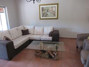 a living room with a couch and a table at faces guesthouse in Bethlehem