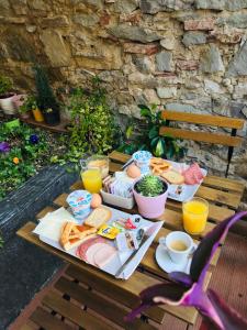 a picnic table with breakfast foods and drinks on it at Hotel Aida in Florence