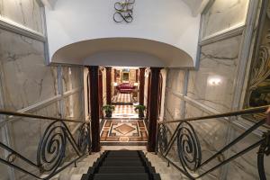 a stairway leading up to a staircase at The Britannia Hotel in Rome