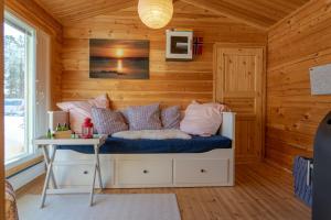 a room with a bed with a table in it at Mökki - The White Blue Wilderness Lodge in Inari