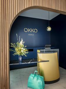 a lobby of a hotel with a desk with a laptop at OKKO Hotels Toulon Centre in Toulon