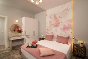 a bedroom with a large bed with pink flowers on it at Sunrise Resort Hotel in Mithymna