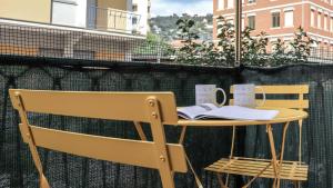 a table and chairs with books on it on a balcony at Italianway - Dogali 17 in Santa Margherita Ligure