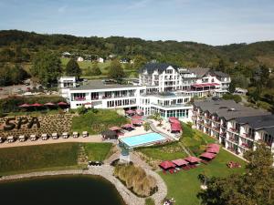an aerial view of a resort with a swimming pool at Moselstern Parkhotel Krähennest in Löf