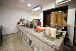 a kitchen with a counter with food on it at Hotel Arawak Upar in Valledupar +49 photos