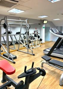 a gym with a lot of equipment in a room at Macdonald Doña Lola Resort in La Cala de Mijas