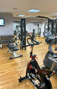 a gym with a bunch of treadmills and machines at Macdonald Doña Lola Resort in La Cala de Mijas