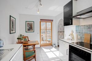 a kitchen with white appliances and a dining room at Ferienwohnung Edelweiß in Schönau am Königssee