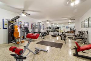 a gym with treadmills and machines in a room at Matchroom Country Club Resort in Fuengirola