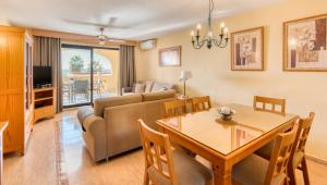 a living room with a table and a couch at Macdonald Doña Lola Resort in La Cala de Mijas