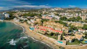 an aerial view of a resort on the beach at Macdonald Doña Lola Resort in La Cala de Mijas