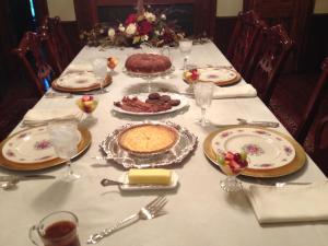 a table with a cake and food on it at Adair Manor Bed & Breakfast in Adairsville