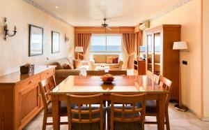 a kitchen and living room with a table and chairs at Macdonald Doña Lola Resort in La Cala de Mijas