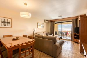 a living room with a couch and a table at Macdonald Doña Lola Resort in La Cala de Mijas