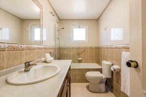 a bathroom with a sink and a toilet at Macdonald Doña Lola Resort in La Cala de Mijas